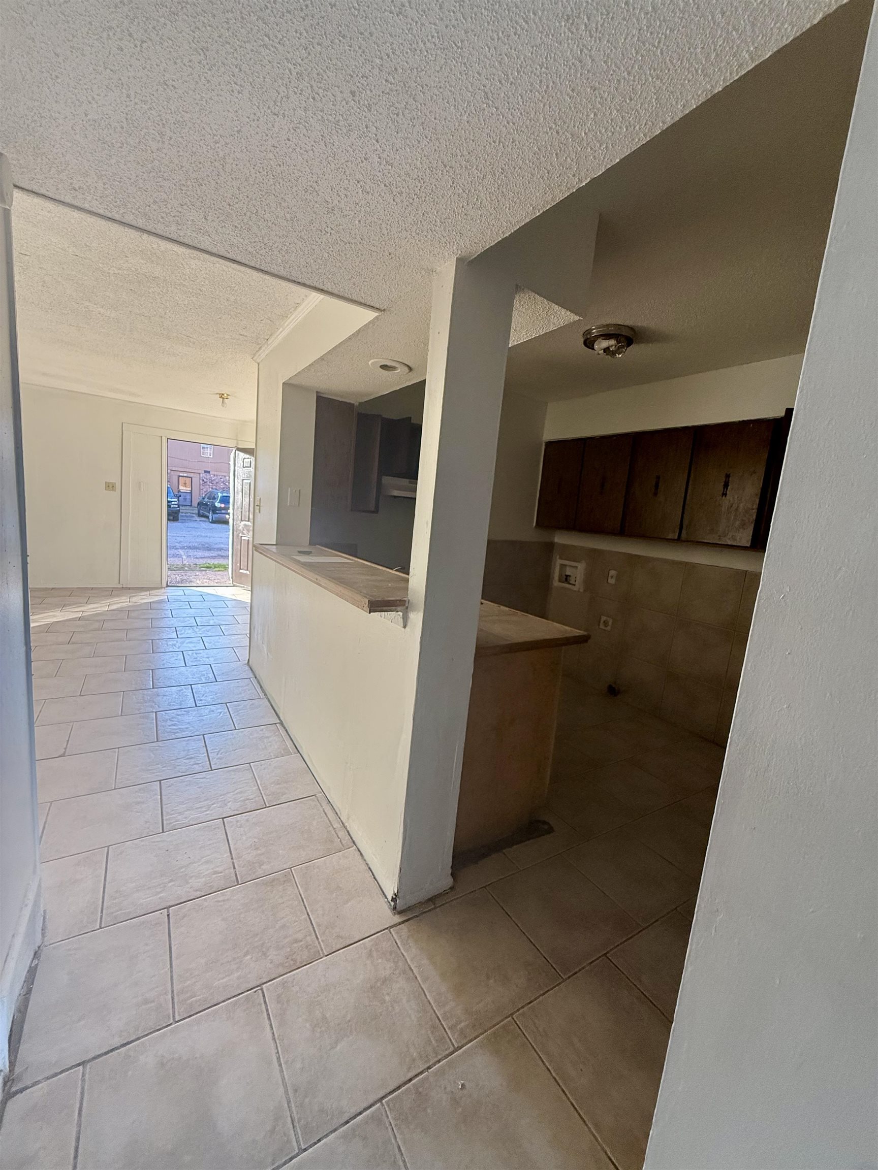 3091 Range Line Road Memphis, TN 38127 - Photo 5 of 13 Hallway featuring a textured ceiling and light tile patterned floors