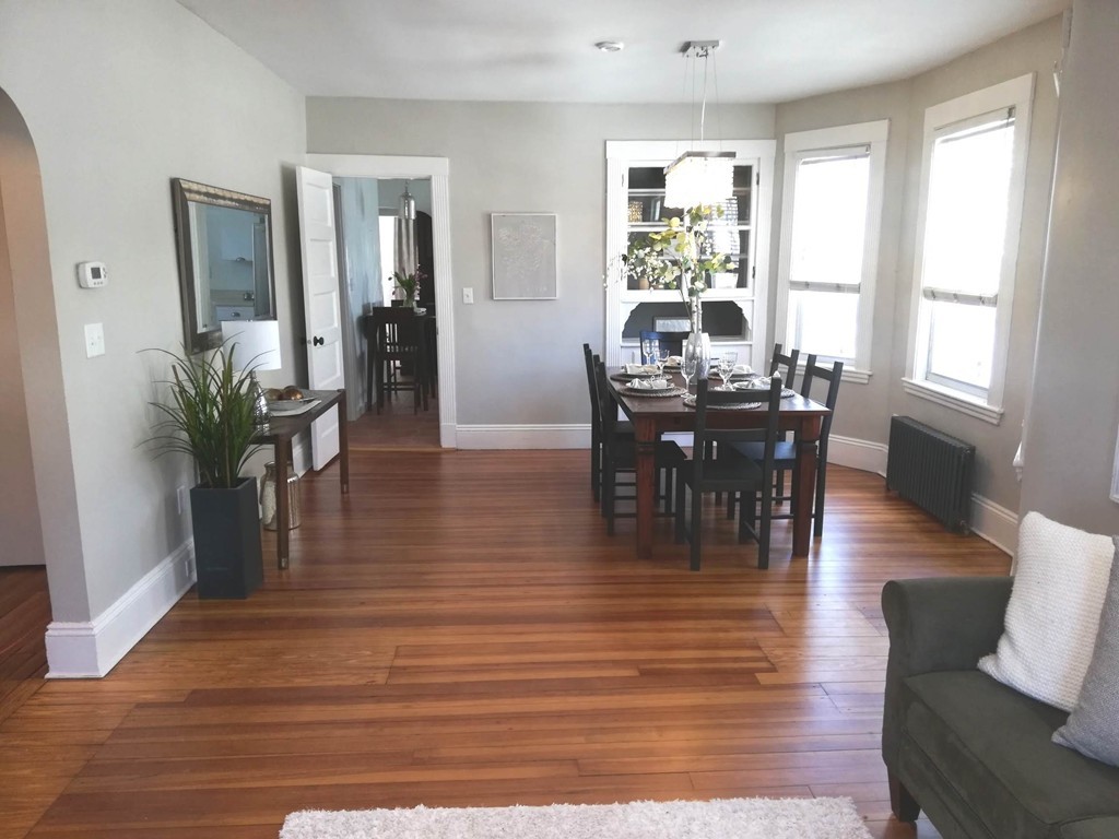 476 Albemarle Road, Unit 1 Newton, MA 02460 - Photo 7 of 20 a view of a dining room with furniture window and wooden floor