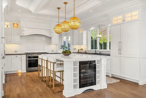 a kitchen with a stove and a wooden floor