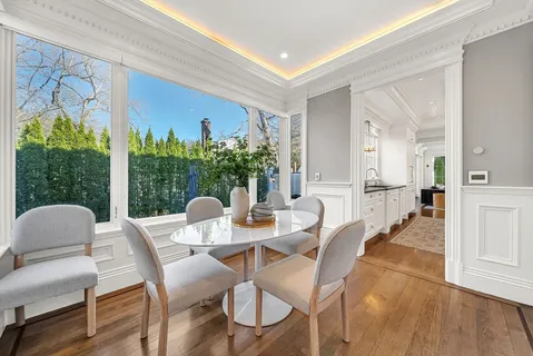 a dining room with furniture and wooden floor