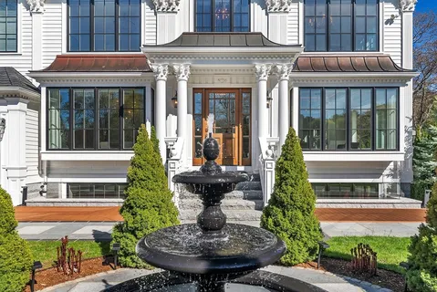 a front view of a house with a fountain