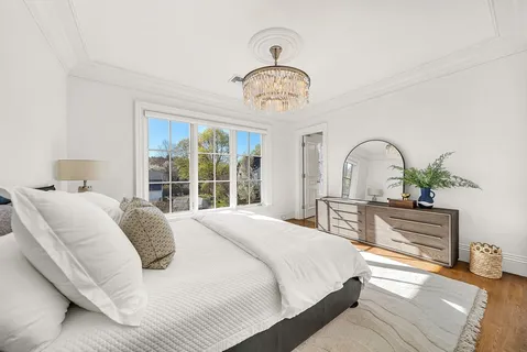 a bedroom with bed and a window
