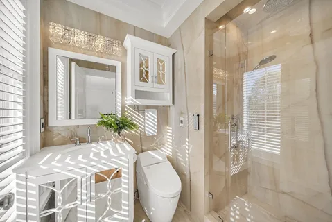 a spacious bathroom with a toilet sink and shower
