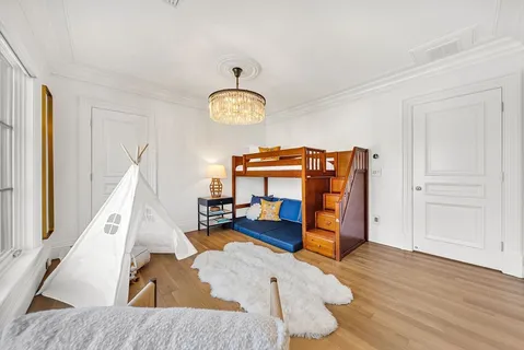 a view of a bedroom with furniture and window