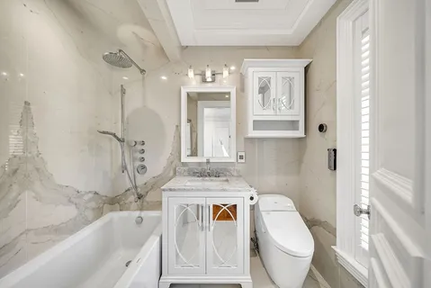 a bathroom with a granite countertop sink toilet and shower