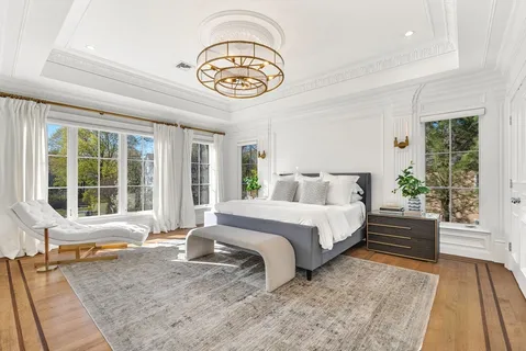 a spacious bedroom with a bed and a large window