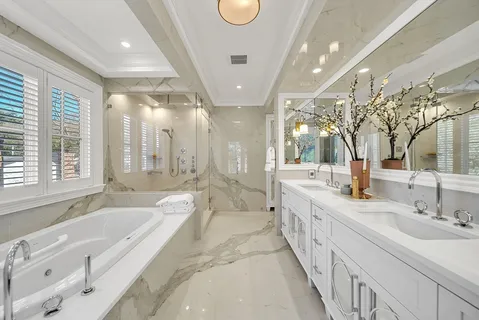 a spacious bathroom with a large tub sink and vanity