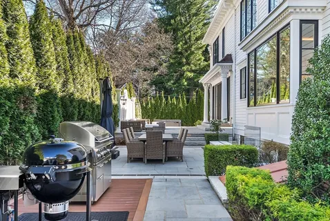 a view of backyard of house with outdoor seating