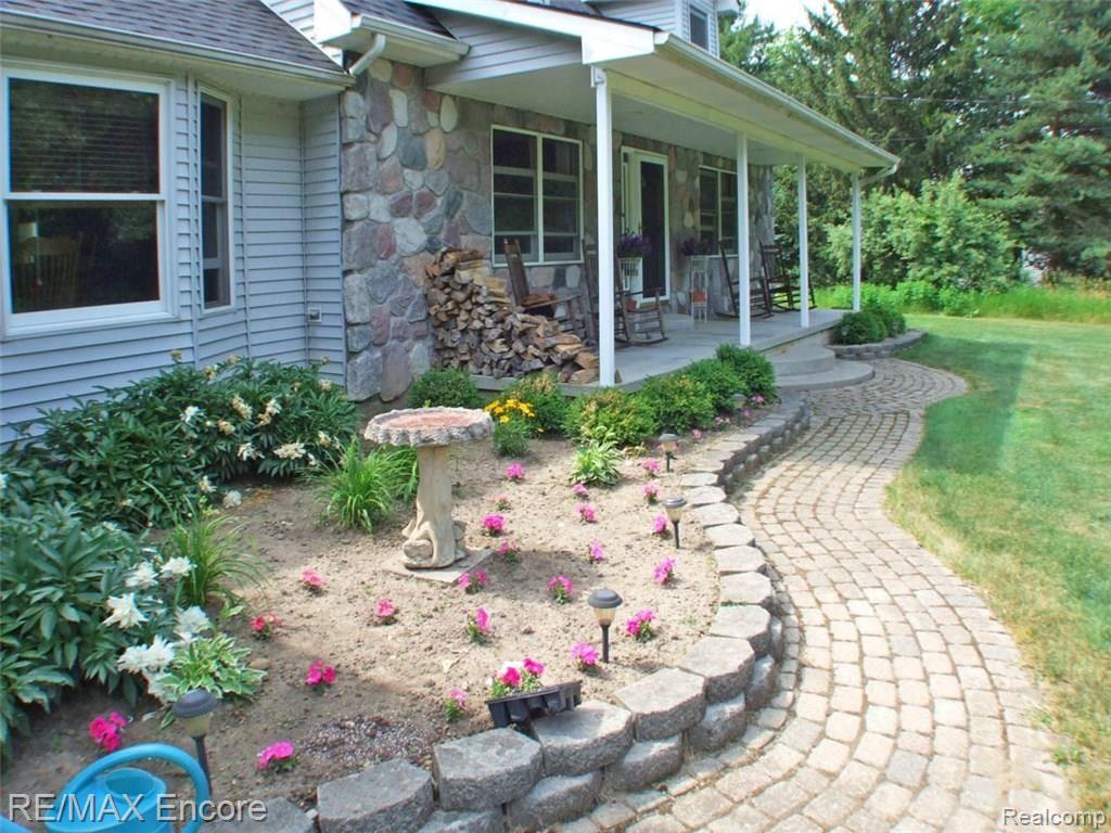8945 Michigamme Road Clarkston, MI 48348 - Photo 4 of 30 Brick pavers compliment stone accents on front