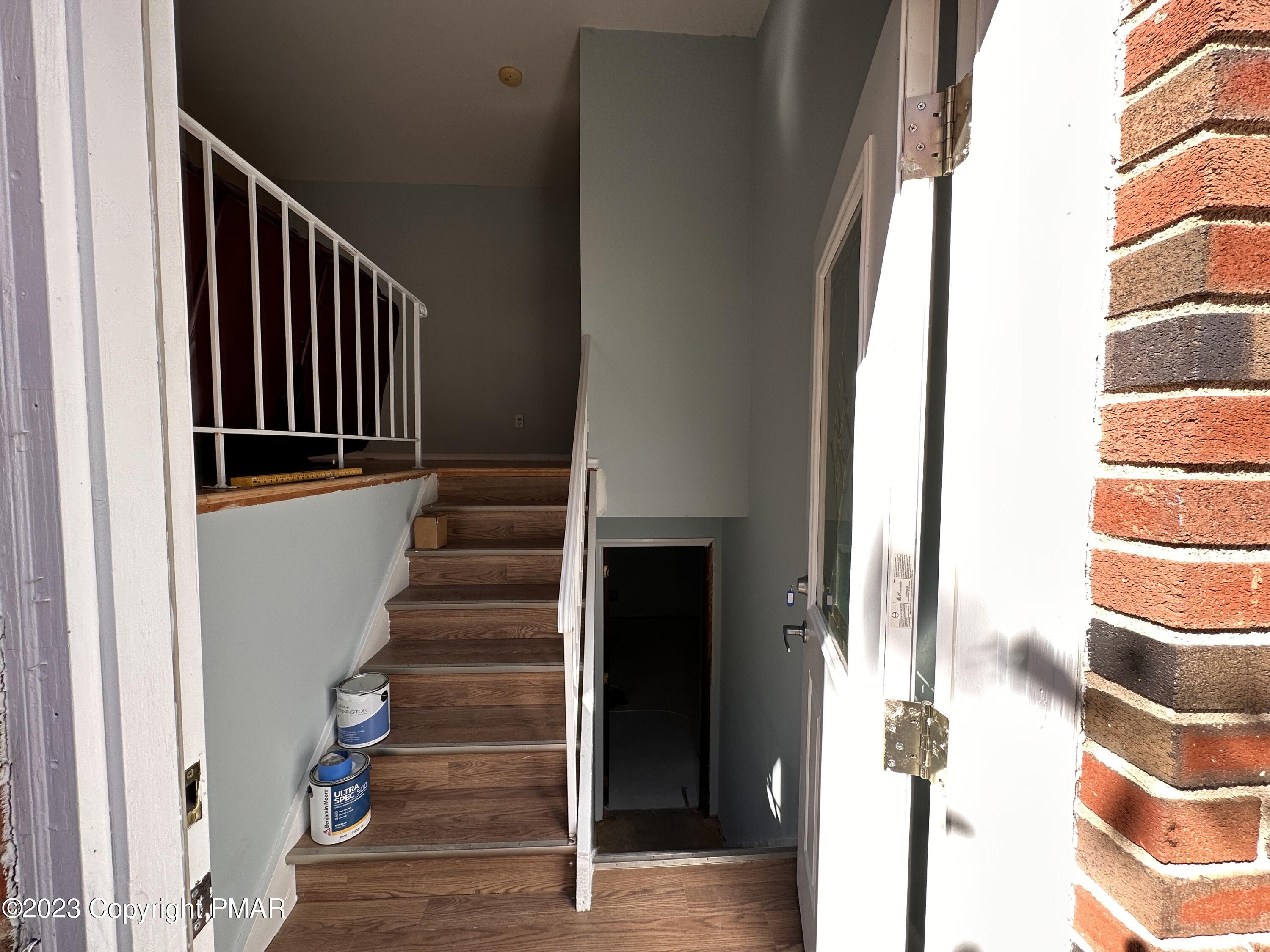 4215 Pine Ridge Drive East Bushkill, PA 18324 - Photo 4 of 18 a view of staircase with white walls and windows
