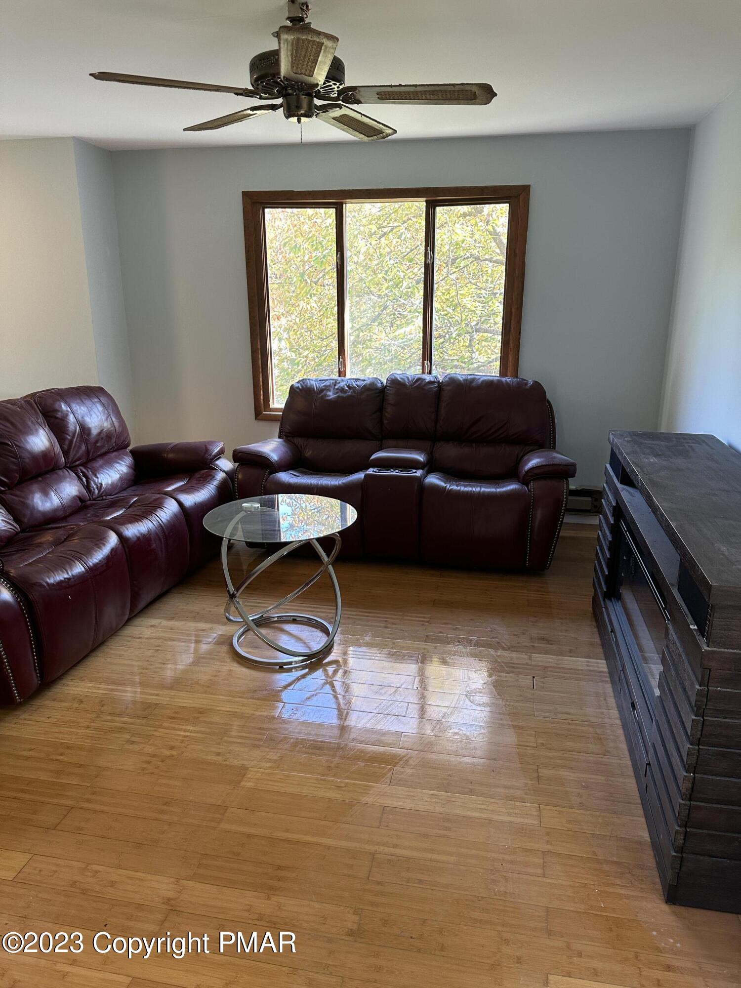 4215 Pine Ridge Drive East Bushkill, PA 18324 - Photo 6 of 18 a living room with furniture and a large window