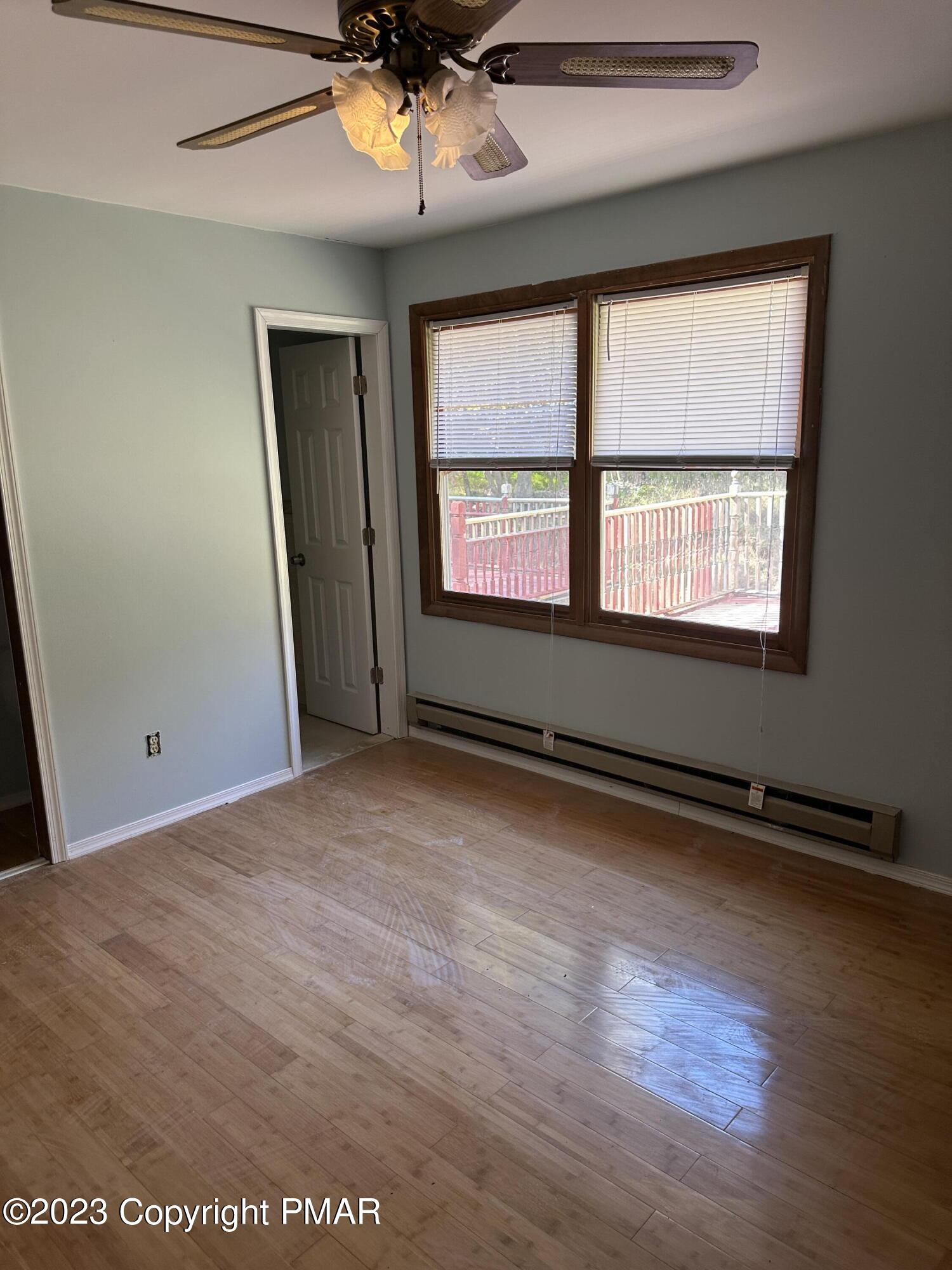 4215 Pine Ridge Drive East Bushkill, PA 18324 - Photo 10 of 18 an empty room with wooden floor and windows