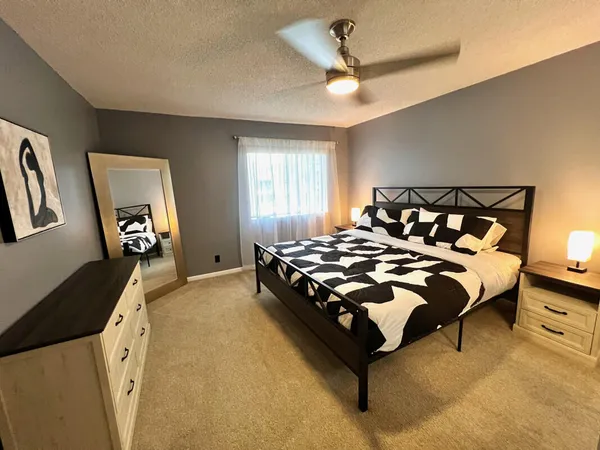 a bedroom with a bed and a chandelier