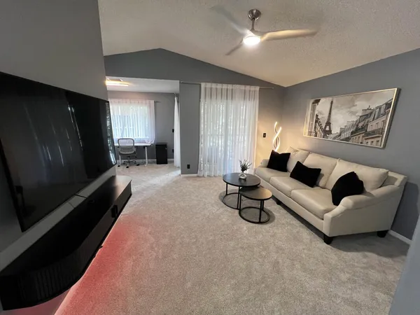 a living room with furniture and a flat screen tv