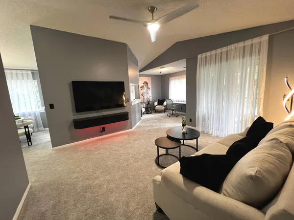 a living room with furniture and a flat screen tv