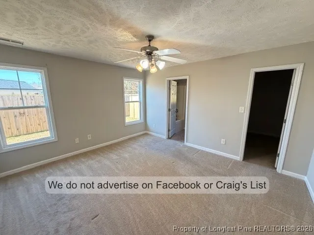 a view of a livingroom with a ceiling fan and window