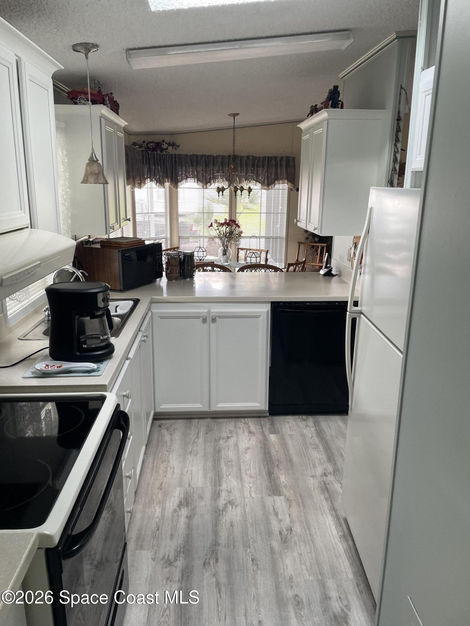7579 Boxelder Road Micco, FL 32976 - Photo 1 of 30 a kitchen with stainless steel appliances a stove a sink and a refrigerator