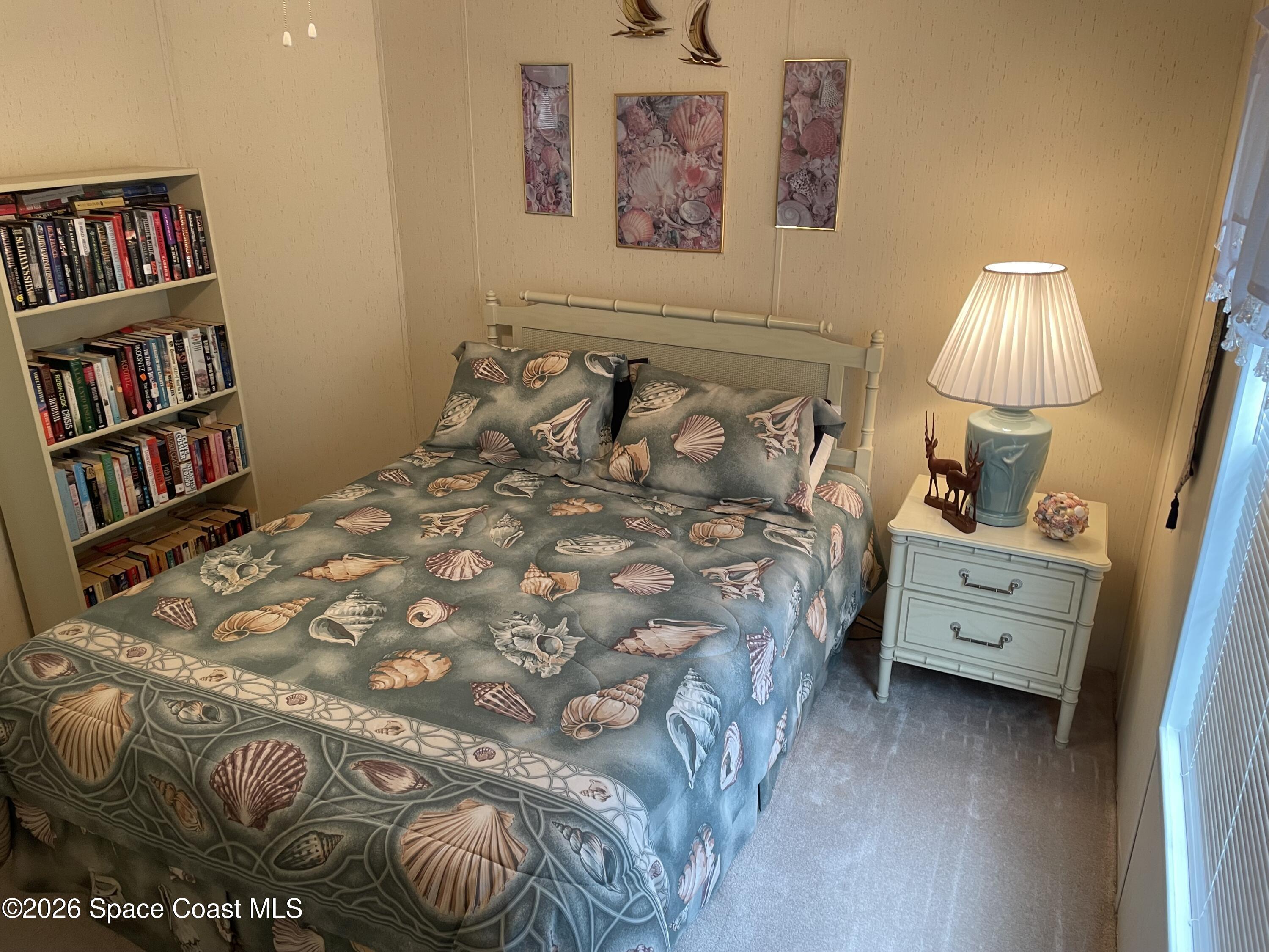 7579 Boxelder Road Micco, FL 32976 - Photo 18 of 30 a bedroom with a bed and a book shelf