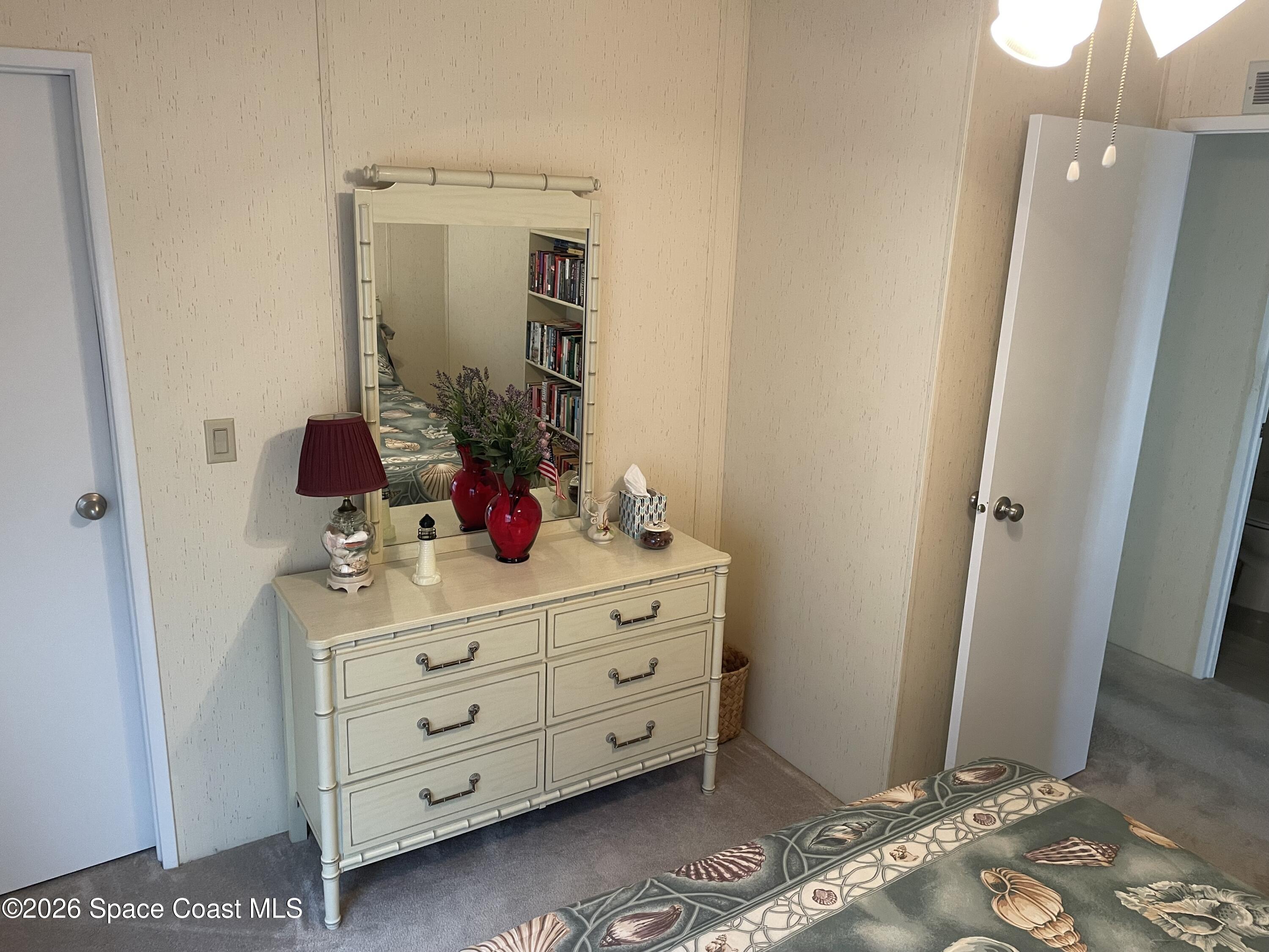 7579 Boxelder Road Micco, FL 32976 - Photo 19 of 30 a view of a bathroom sink and mirror