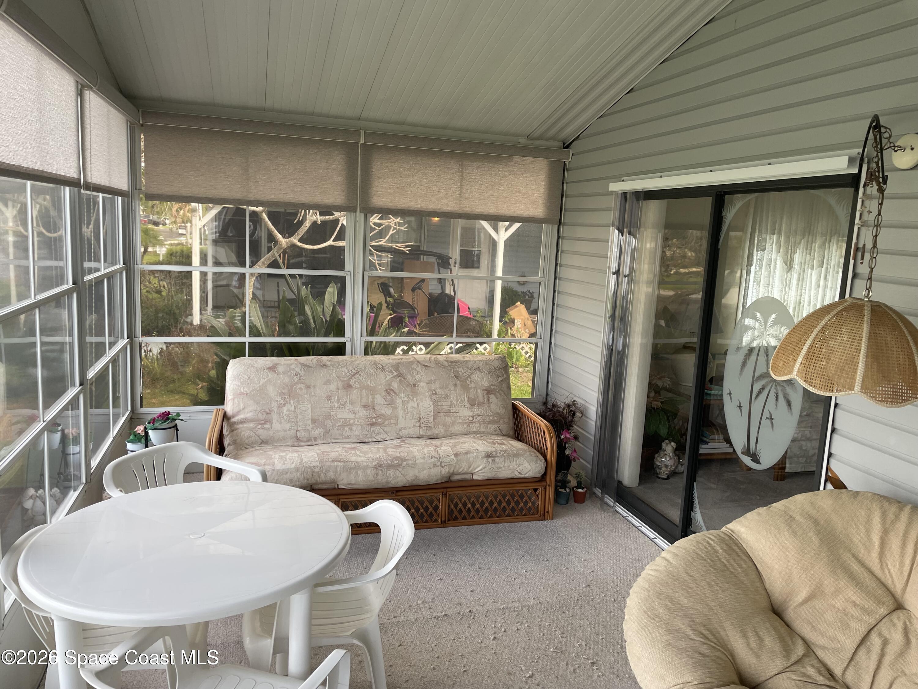 7579 Boxelder Road Micco, FL 32976 - Photo 21 of 30 a living room with furniture and a table