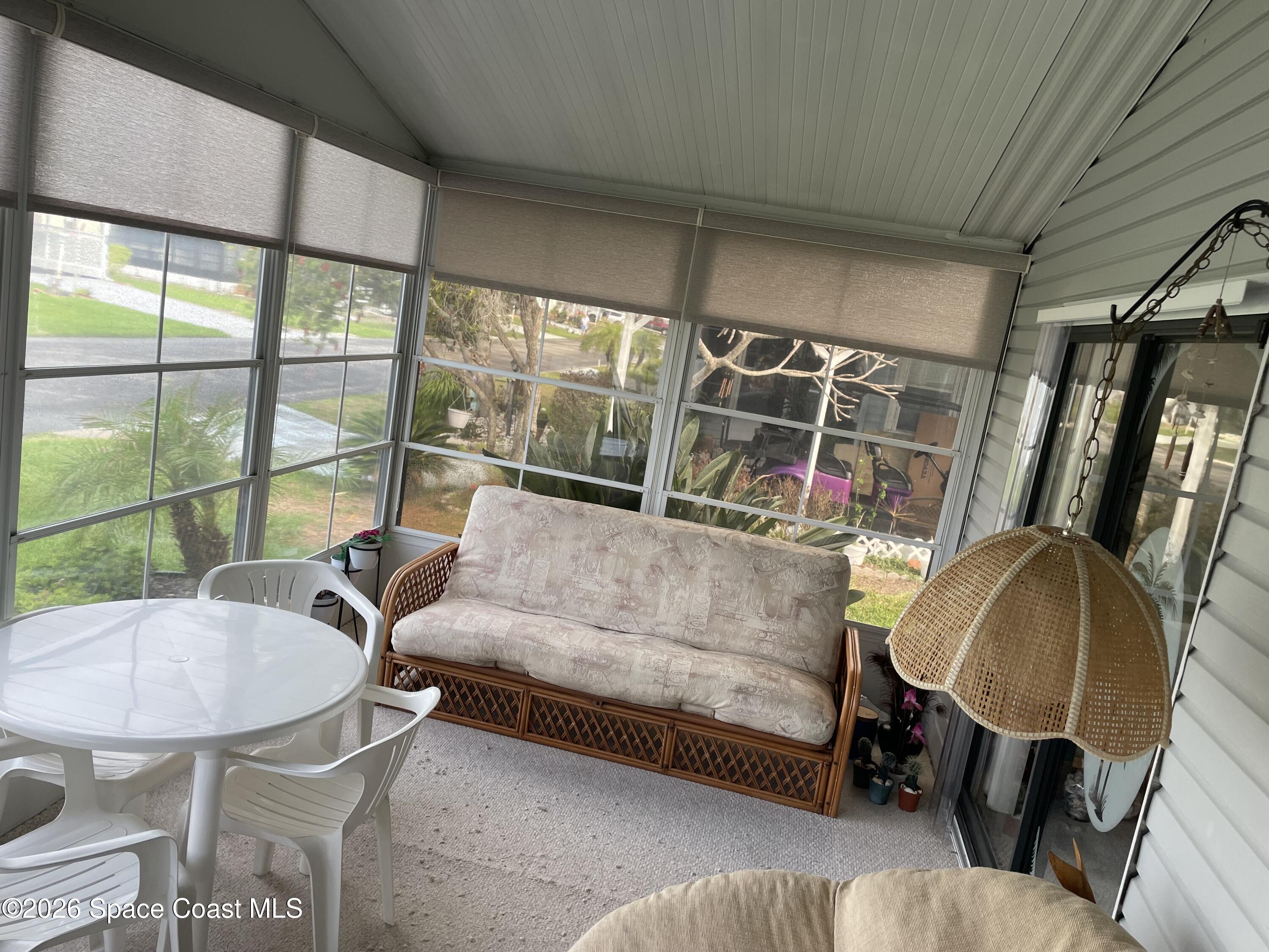 7579 Boxelder Road Micco, FL 32976 - Photo 22 of 30 a living room with furniture and a floor to ceiling window