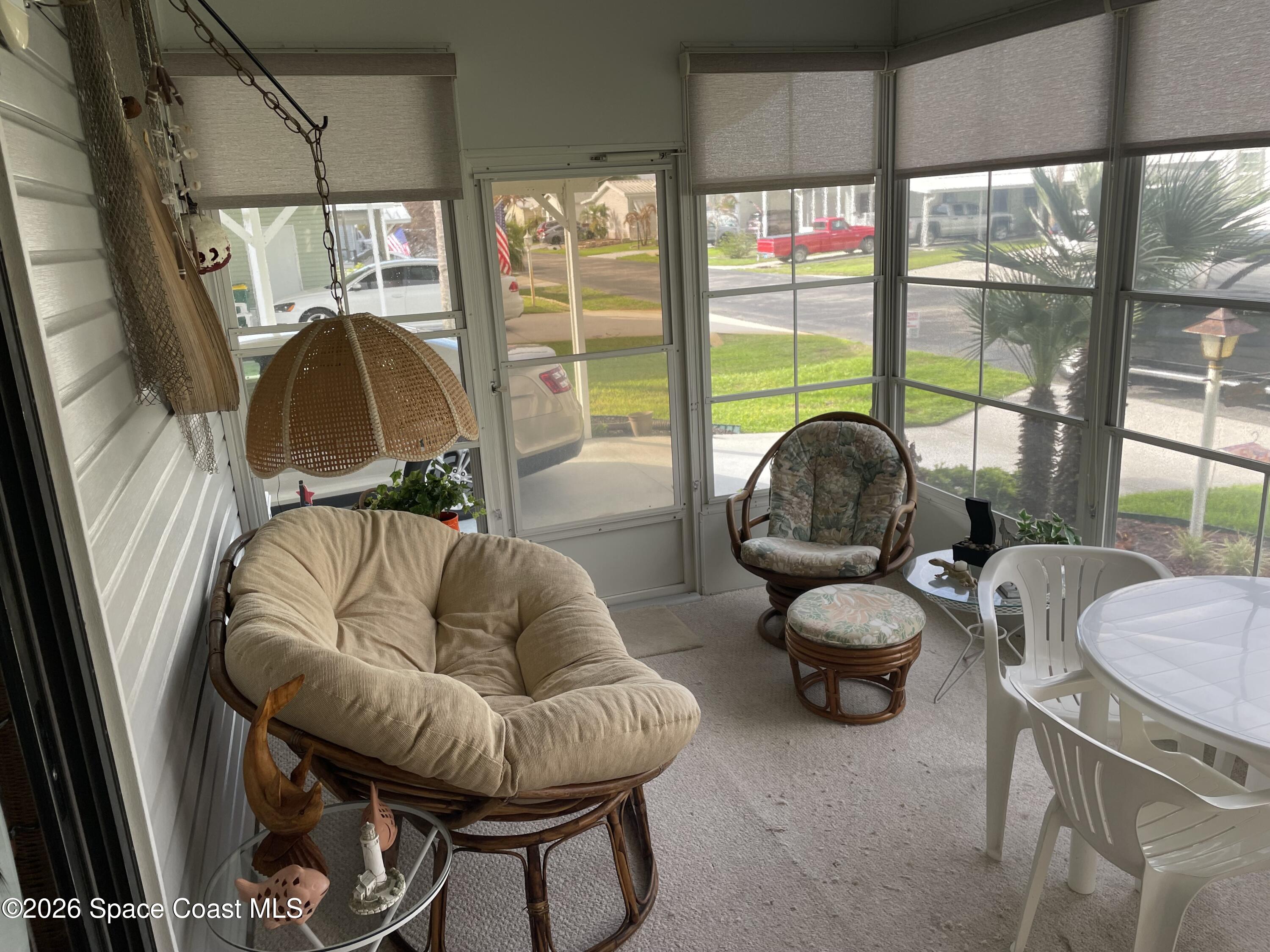 7579 Boxelder Road Micco, FL 32976 - Photo 23 of 30 a living room with furniture and a floor to ceiling window