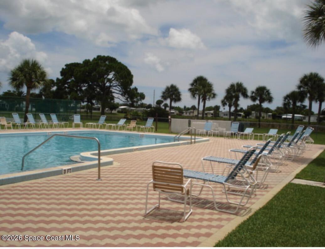7579 Boxelder Road Micco, FL 32976 - Photo 25 of 30 swimming pool view with a lake view