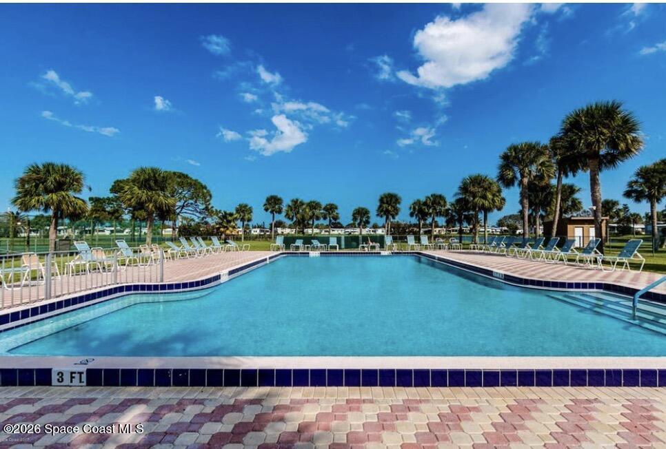 7579 Boxelder Road Micco, FL 32976 - Photo 26 of 30 a view of a swimming pool with a yard