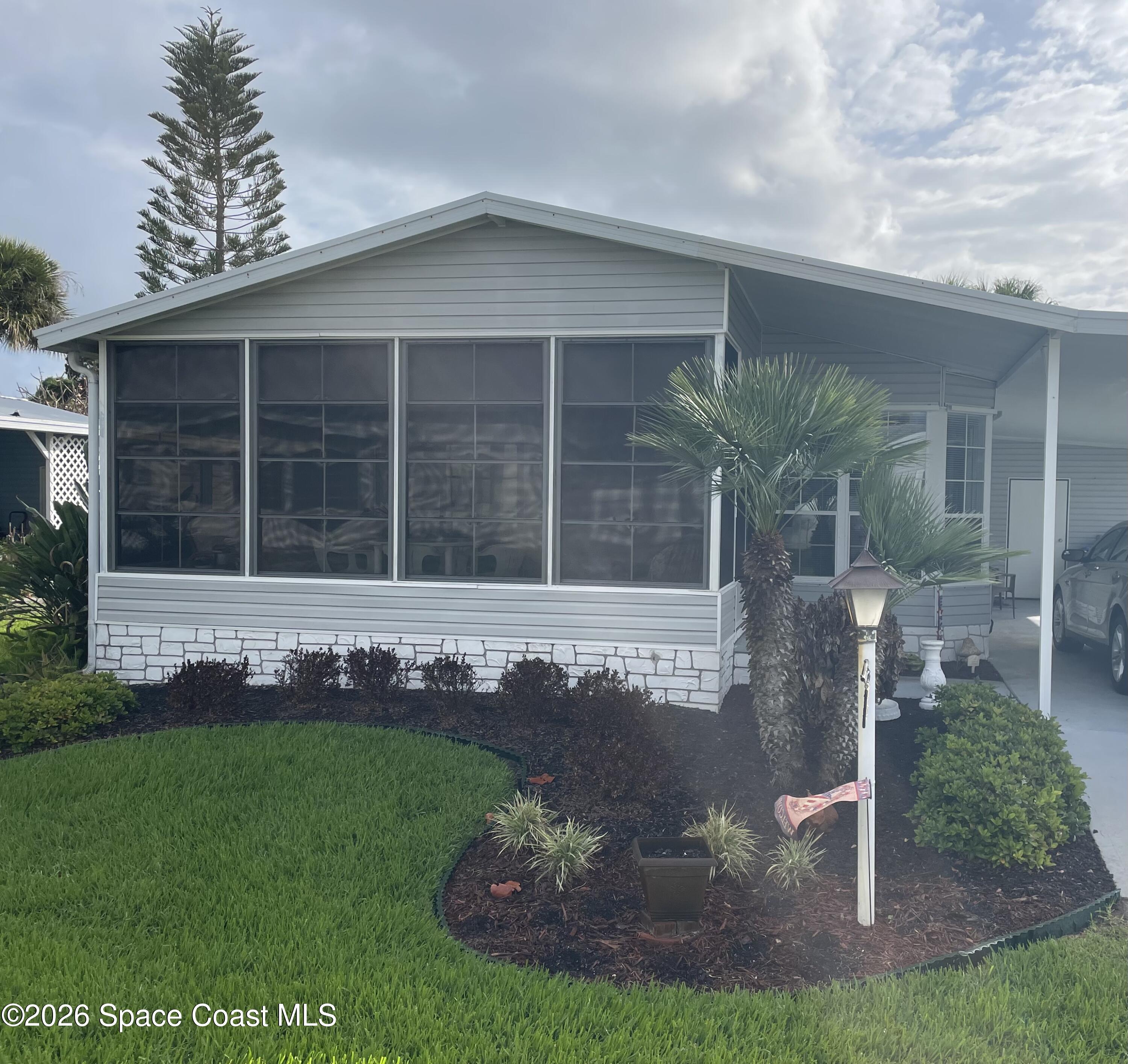 7579 Boxelder Road Micco, FL 32976 - Photo 30 of 30 a front view of a house with a yard