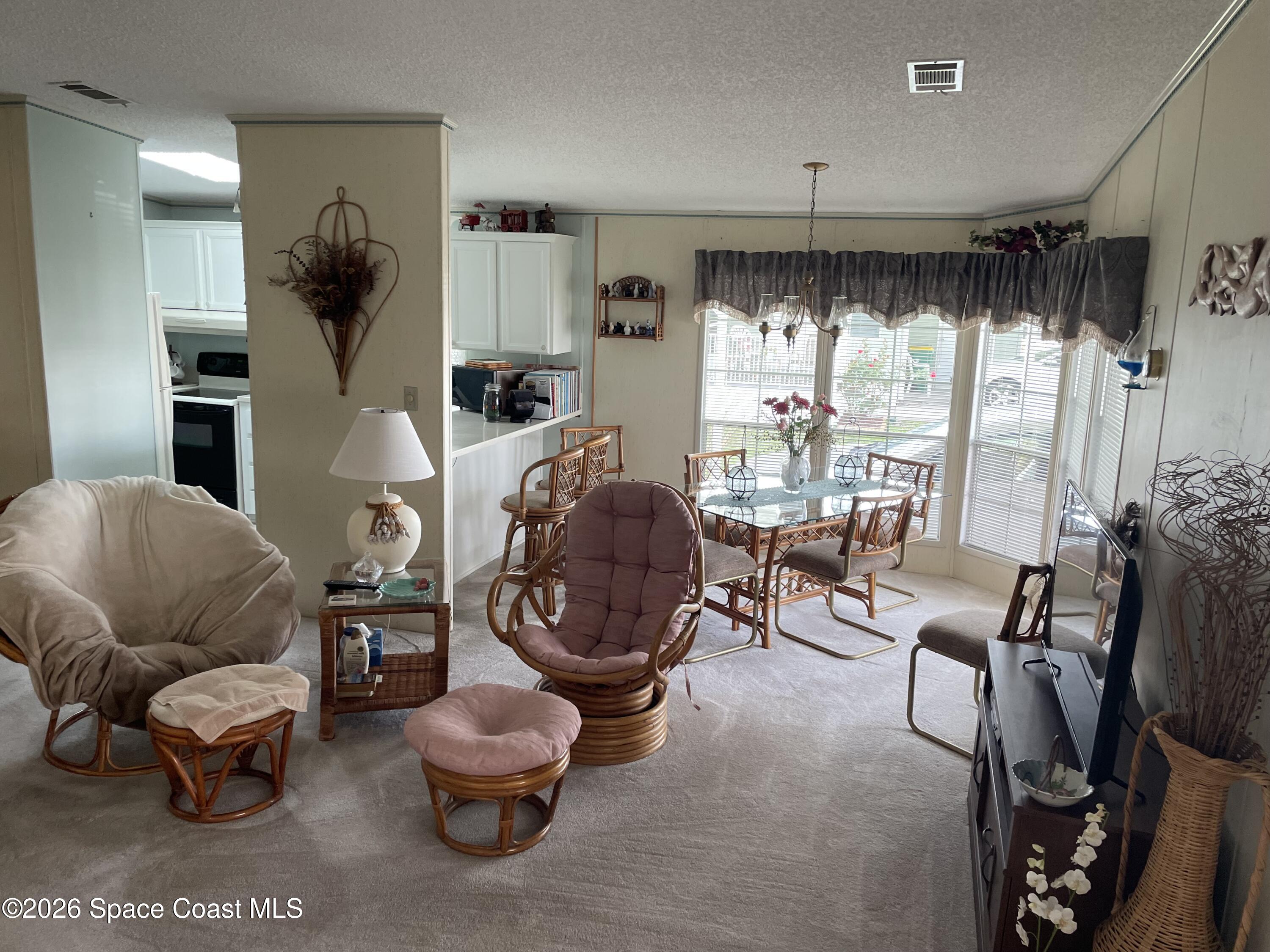 7579 Boxelder Road Micco, FL 32976 - Photo 4 of 30 a living room with furniture and a large window