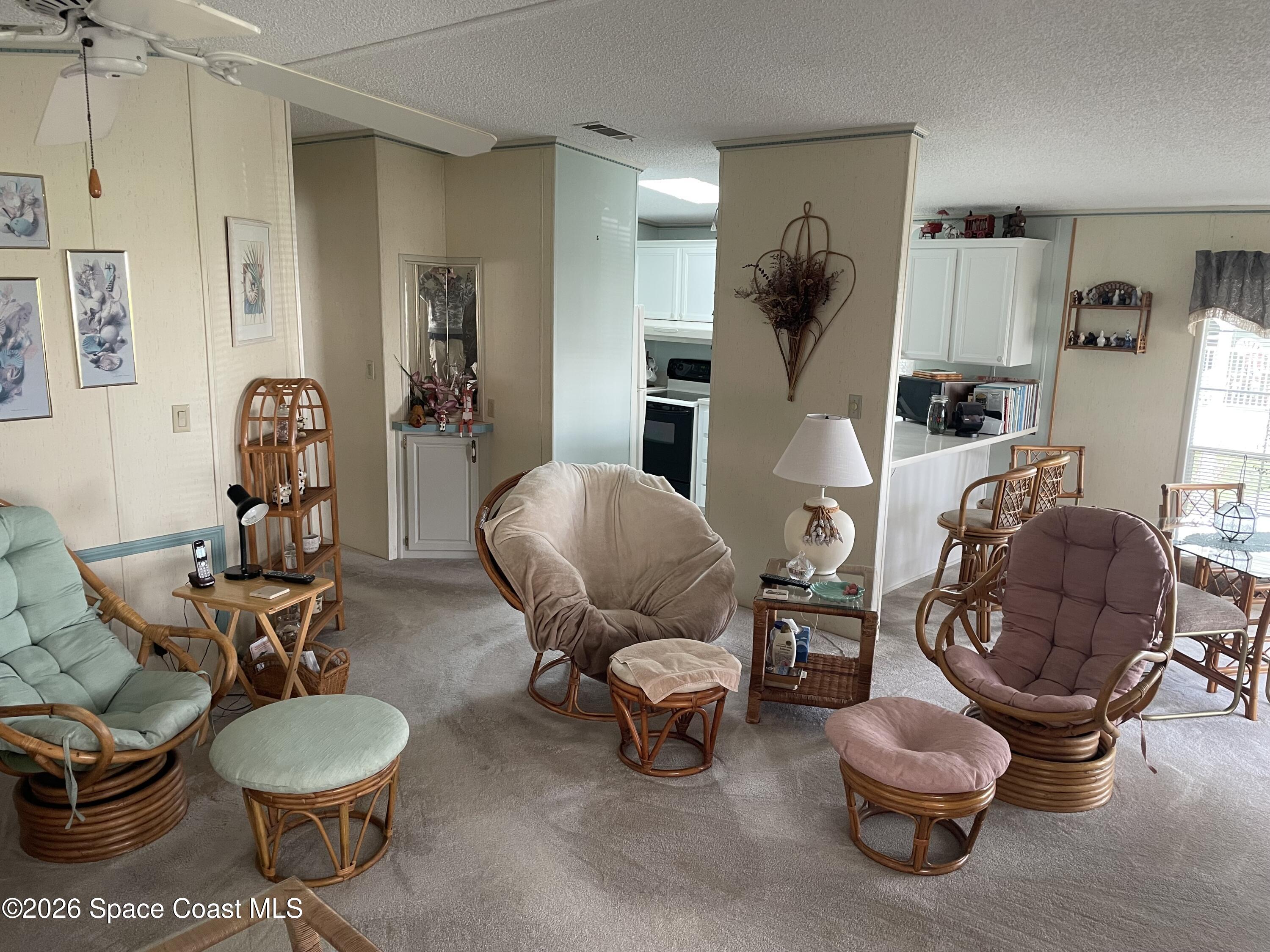 7579 Boxelder Road Micco, FL 32976 - Photo 5 of 30 a living room with furniture and a chair