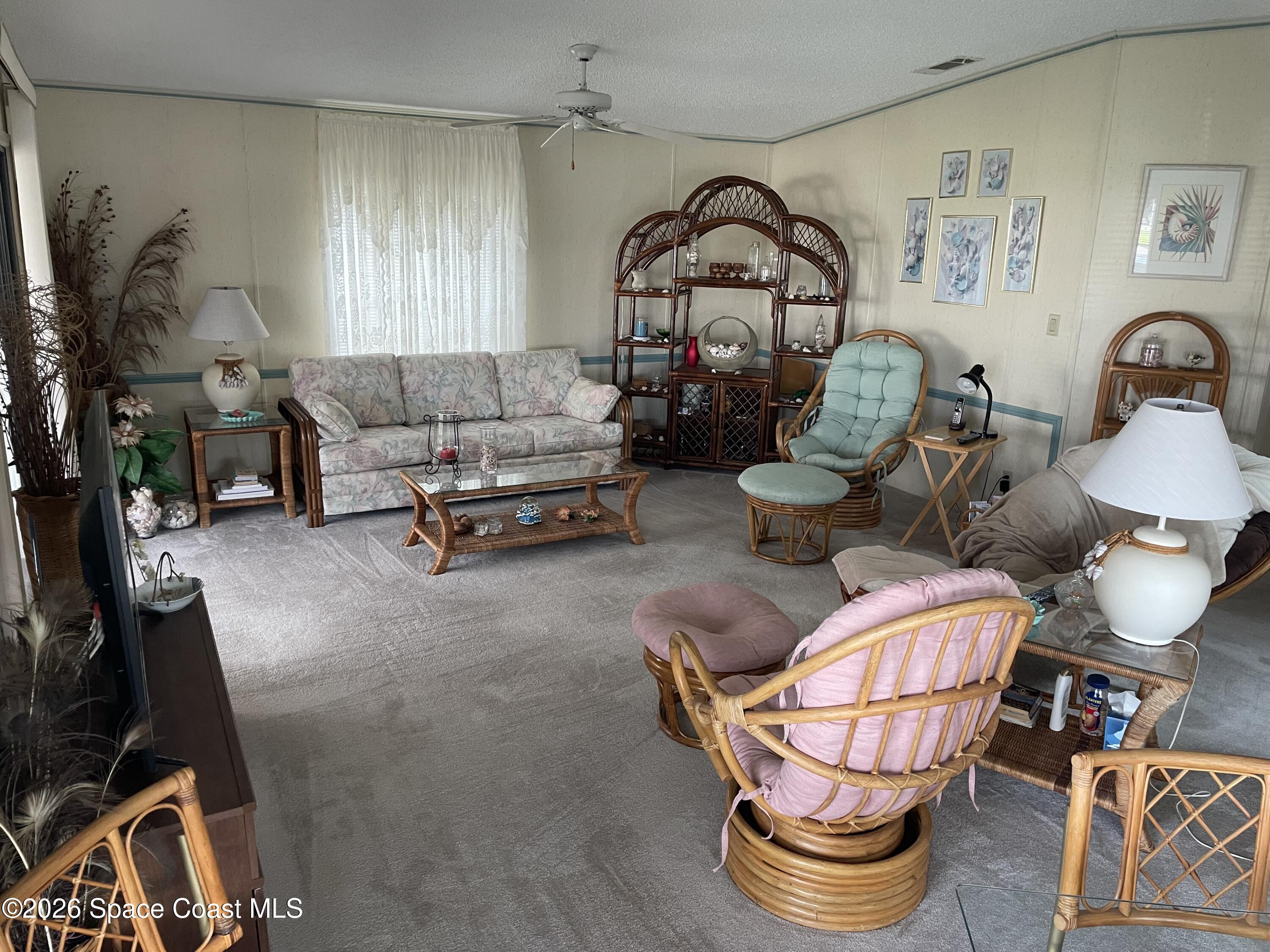 7579 Boxelder Road Micco, FL 32976 - Photo 7 of 30 a living room with furniture a rug and a window