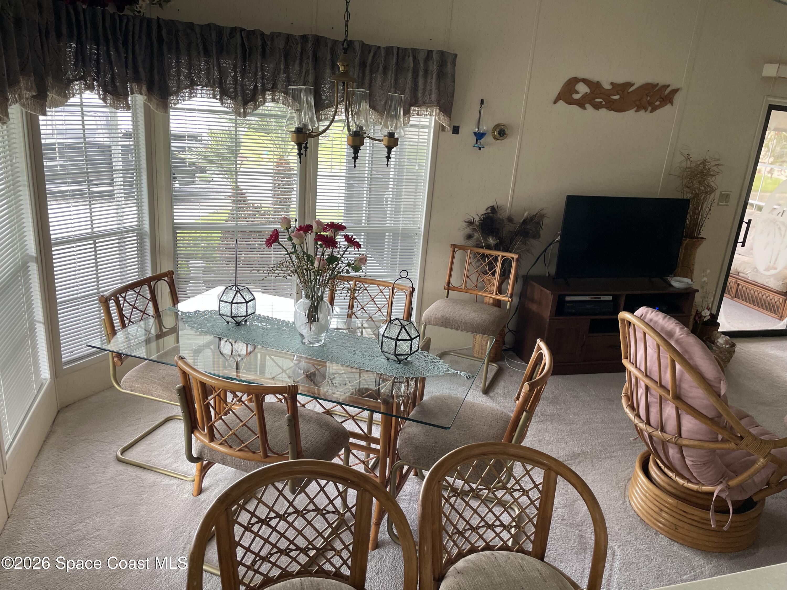 7579 Boxelder Road Micco, FL 32976 - Photo 9 of 30 a living room with furniture and a flat screen tv