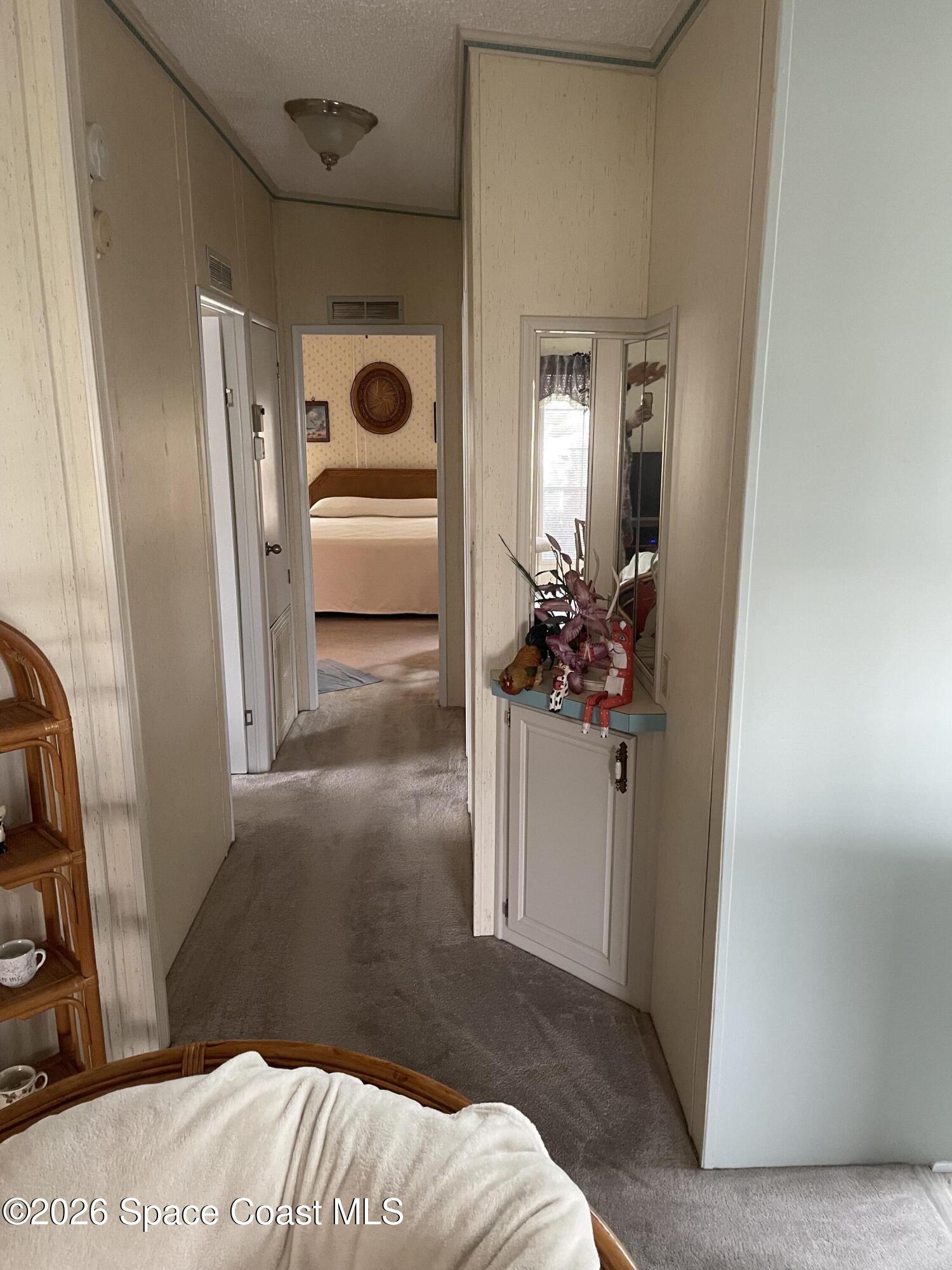 7579 Boxelder Road Micco, FL 32976 - Photo 10 of 30 a bedroom with a bed and a hallway