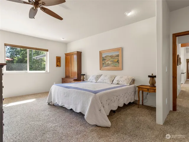 a spacious bedroom with a bed and a table