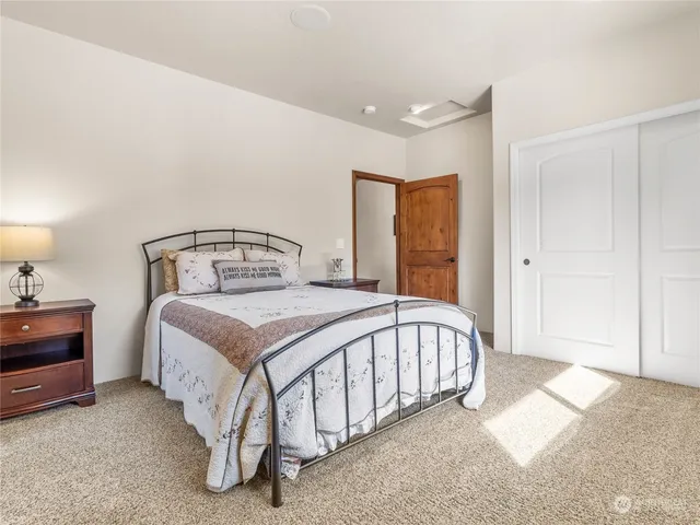 a bedroom with a bed and a dresser