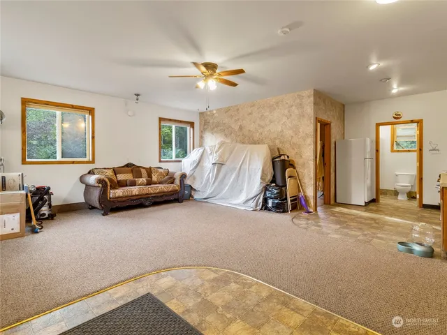 a living room with furniture a window and a flat screen tv