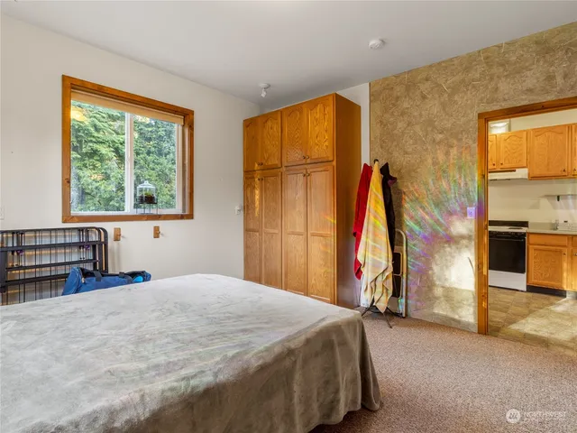 a bed sitting in a bedroom next to a window