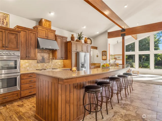 a large kitchen with a table and chairs