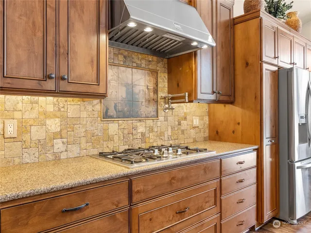 a kitchen with granite countertop cabinets and white appliances