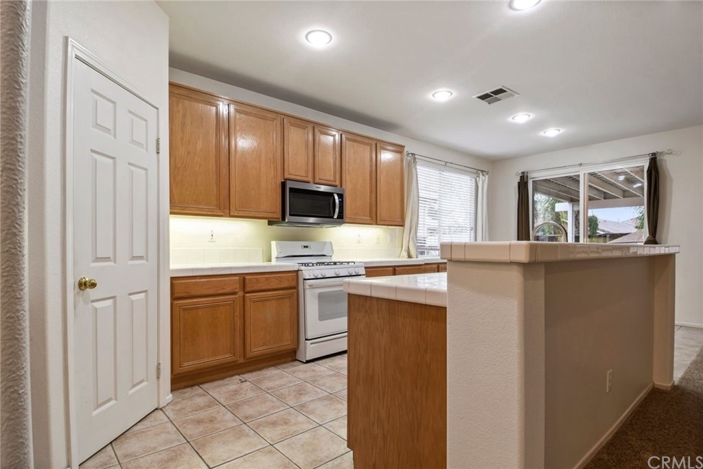 32175 Beaulieu Road Winchester, CA 92596 - Photo 13 of 31 a kitchen with stainless steel appliances granite countertop a refrigerator sink and stove