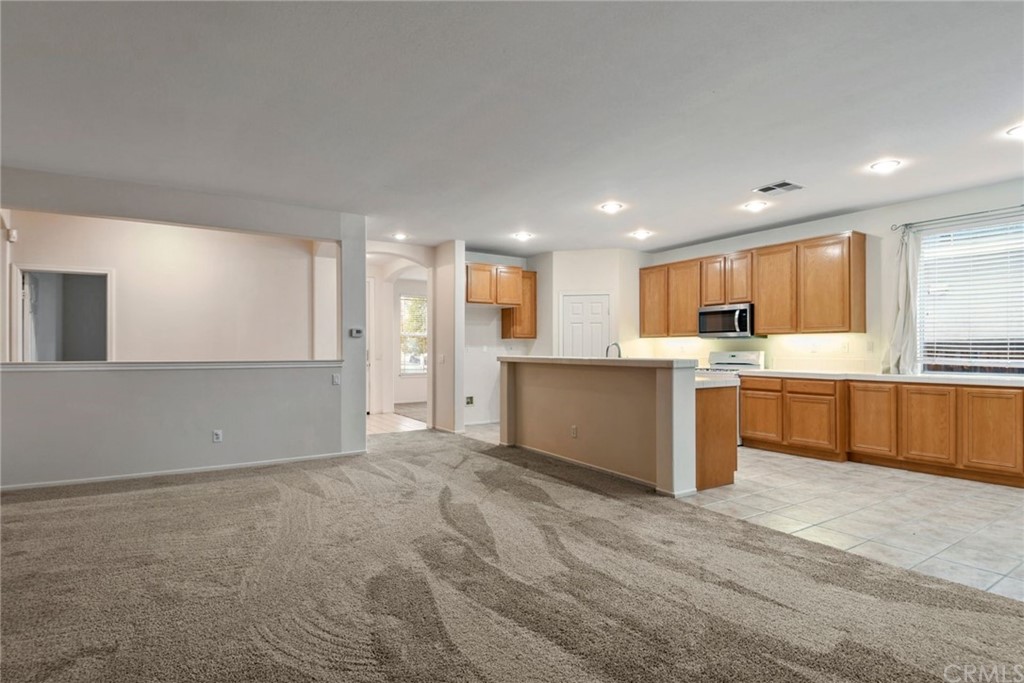 32175 Beaulieu Road Winchester, CA 92596 - Photo 15 of 31 a large white kitchen with a stove a sink dishwasher and a refrigerator