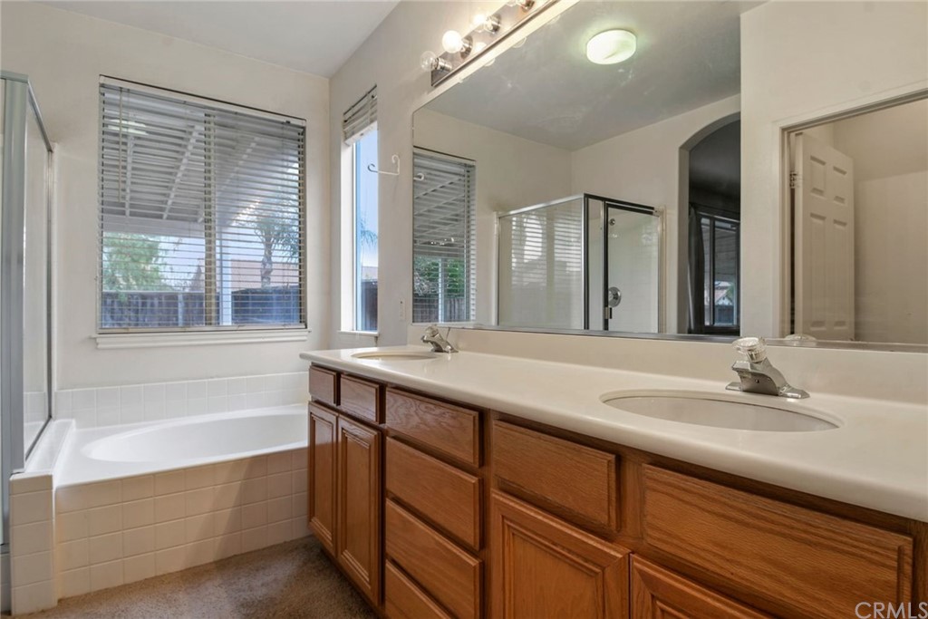 32175 Beaulieu Road Winchester, CA 92596 - Photo 18 of 31 a bathroom with a tub sink and mirror