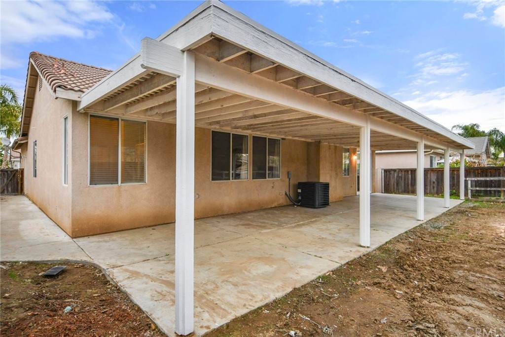 32175 Beaulieu Road Winchester, CA 92596 - Photo 30 of 31 a view of house with wooden floor and floor to ceiling window