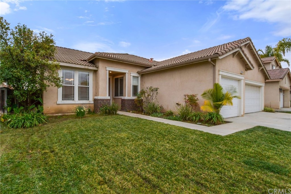 32175 Beaulieu Road Winchester, CA 92596 - Photo 31 of 31 a front view of a house with a yard and garage