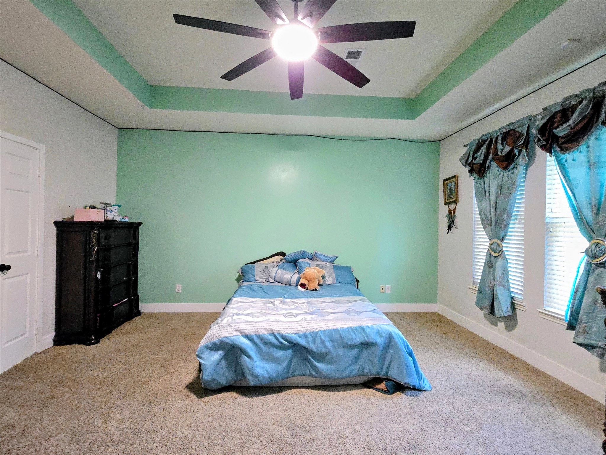 9211 Memorial Grove Drive Spring, TX 77379 - Photo 11 of 38 a bedroom with a bed and a chandelier