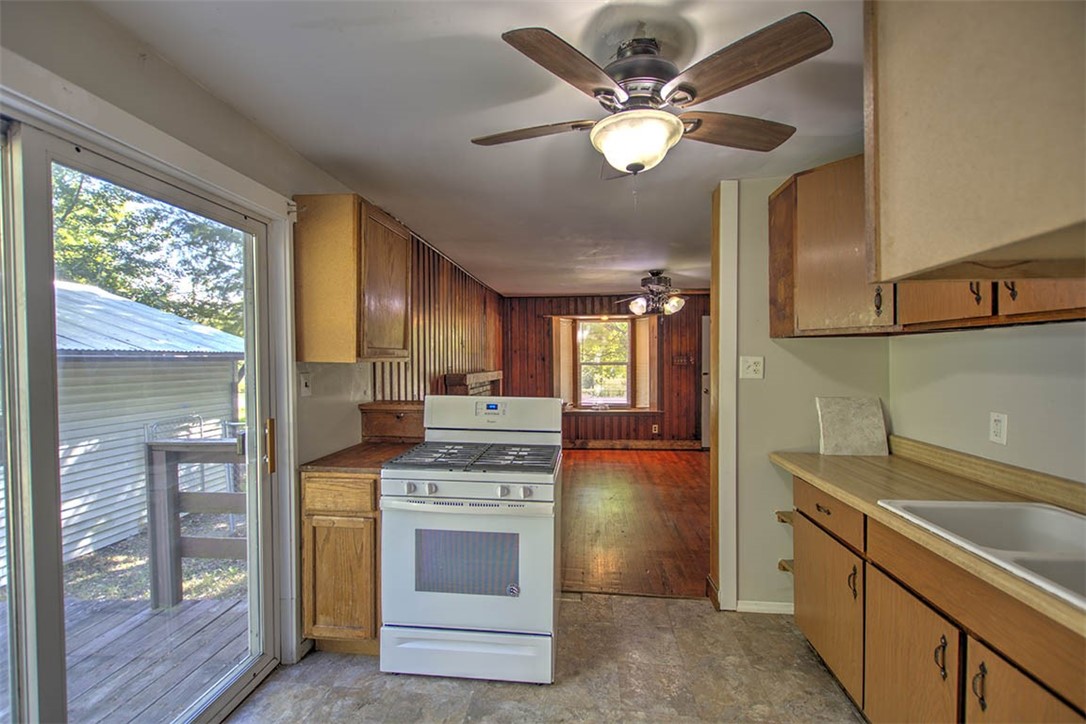 7450 West William Street Decatur, IL 62522 - Photo 5 of 18 a kitchen with a stove a sink and a refrigerator