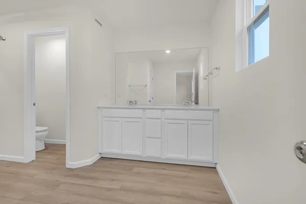 a bathroom with a sink a toilet and a light fixture