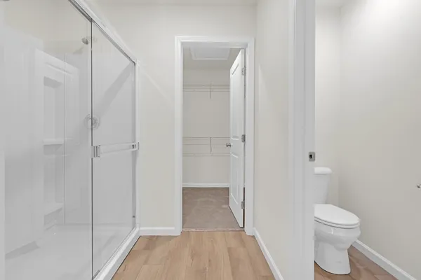 a bathroom with a toilet and a shower