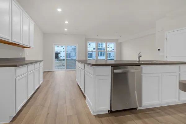 a kitchen with granite countertop a sink and cabinets